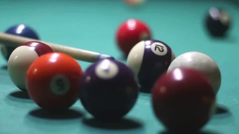 Multi-colored billiard balls scatter from a cue hit in video Stock Footage 339029280