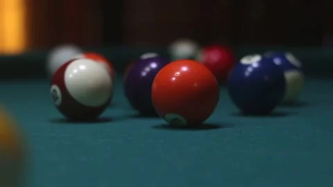 Multi-colored billiard balls scatter from the impact Stock Footage 339029300