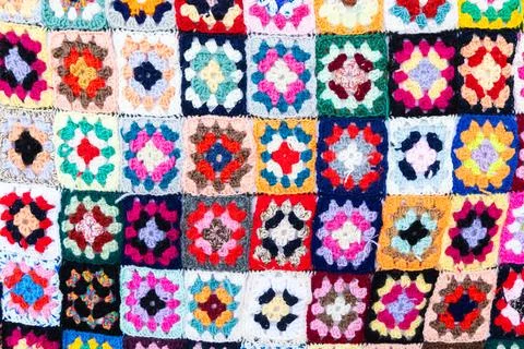 Multi colored blanket in wool, square geometric background, retro decorativ.. Stock Photos