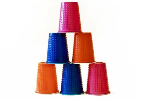 Multi-colored blue, orange and pink plastic cups on a white background. Tower Stock-Fotos