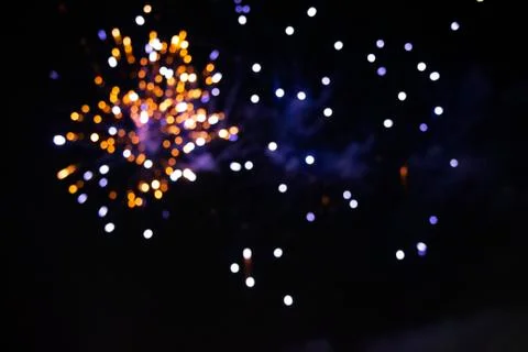 Multi-colored bokeh spots of fireworks on black background. 스톡 사진