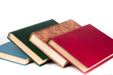 Multi-colored books lie chaotically in isolated on white background Stock Photos