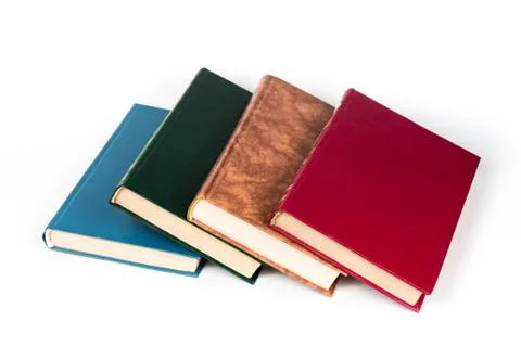 Multi-colored books lie chaotically in isolated on white background Foto stock