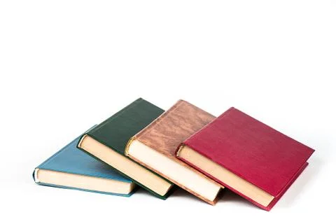 Multi-colored books lie chaotically in isolated on white background Stock Photos