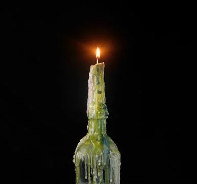 Multi-Colored Bottle Candle on Black Background Stock Photos