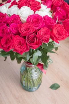 Multi-colored bouquet of red, pink and white roses in a vase Stock Photos