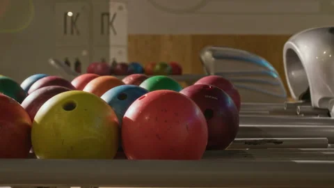 Multi Colored Bowling Balls Resting on Return Machine in Sports Club Stock Footage 337093702