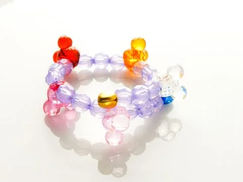 Multi-colored bracelets with beads. Colourful child's bead bracelet.. Stock Photos