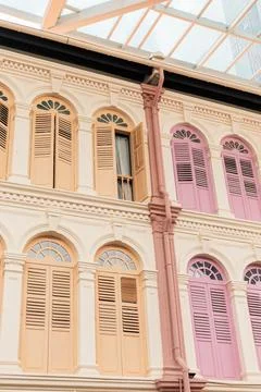 Multi-colored building facades show a mix of peach, pink, and cream shades. W Stock Photos
