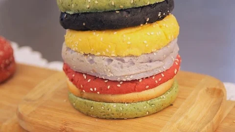Multi colored buns for hamburger, close up. Moving camera, panning. Stock Footage 74701887