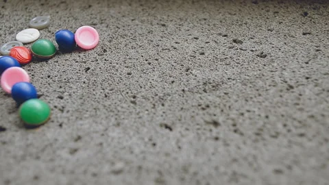 Multi-colored buttons on concrete Stock Footage 93499728