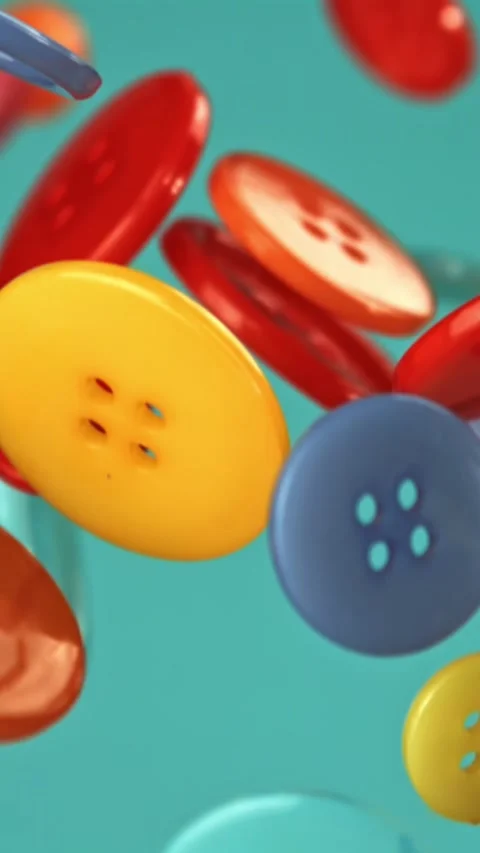 Multi-colored buttons fly on a blue background. Filmed on a high-speed camera at Stock Footage 335372910