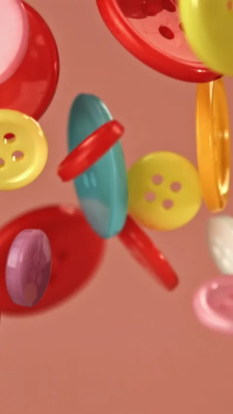 Multi-colored buttons fly on a colored background. Filmed on a high-speed camera Stock Footage 335378750