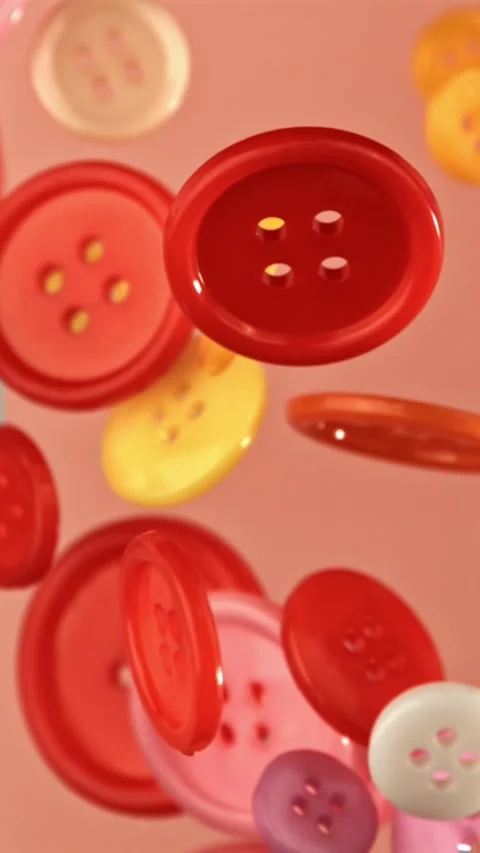 Multi-colored buttons fly on a colored background. Filmed on a high-speed camera Stock Footage 335383954