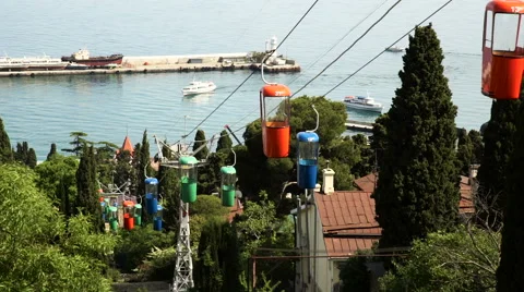 Multi-colored cabins of the funicular on the bank of the Black Sea, Yalta, the 스톡 동영상 64663636