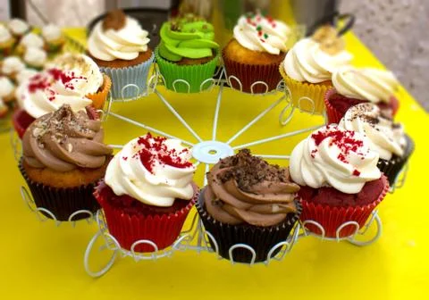 Multi-colored cakes on a round tray Stock Photos