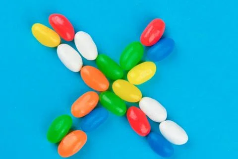 Multi colored candies on a blue background. Tasty colorful candies on blue ba Foto stock