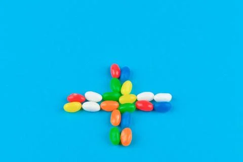 Multi colored candies on a blue background. Tasty colorful candies on blue ba Fotos Stock