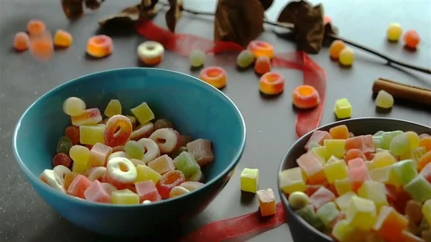 Multi colored candies falling into bowl in slow motion Stock Footage 96277238