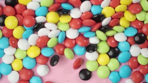 Multi-colored candy dragees move shaking against Stock Footage 205466490