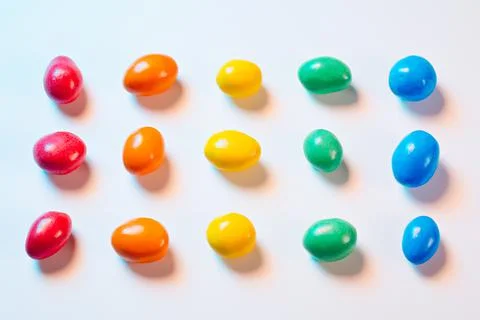 Multi-colored candy in multi-colored light Stock Photos
