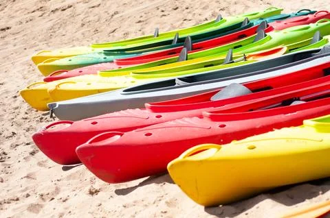 Multi-colored canoes on the sand Foto stock