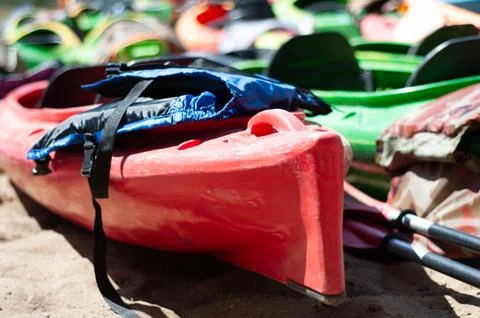 Multi-colored canoes on the sand Stock Photos