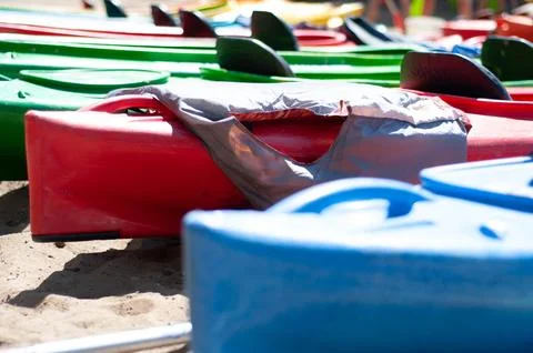 Multi-colored canoes on the sand Stock Photos