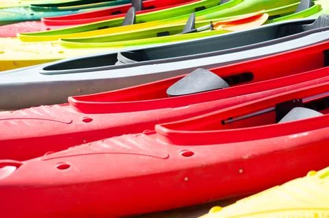 Multi-colored canoes on the sand Stock Photos