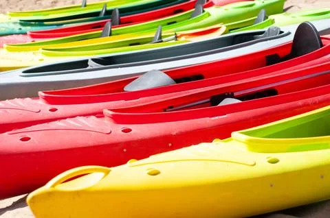 Multi-colored canoes on the sand Stock Photos