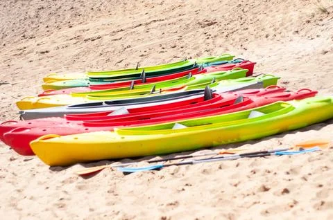 Multi-colored canoes on the sand Stock Photos