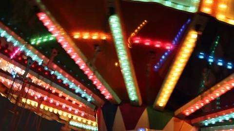 Multi-colored carousel lights at a fair in the evening Video stock 121413756