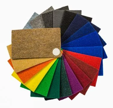 Multi-colored carpeting samples by a fan Stock Photos