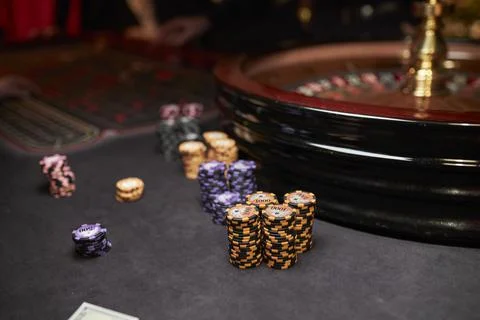 Multi-colored casino chips. Gaming table in a luxury casino. Stock Photos