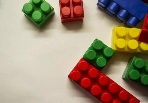 A multi-colored children's designer is lying on a white light table Stock Photos