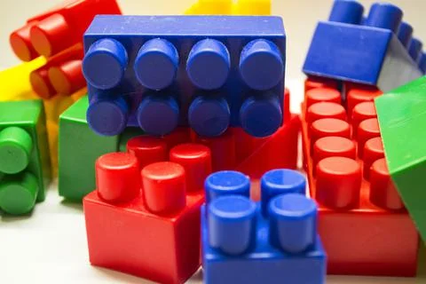 A multi-colored children's designer is lying on a white light table Stock Photos