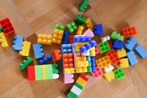 Multi-colored children's designer. scattered across the floor Stock-Fotos