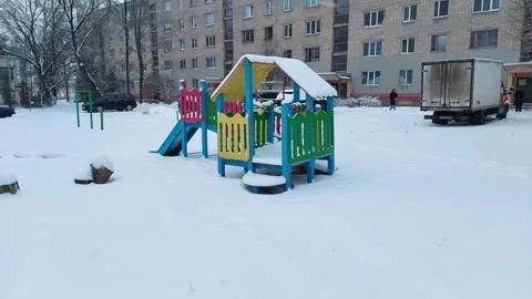 A multi-colored childrens playground with a childrens house and a slide for Stock Footage 300343694