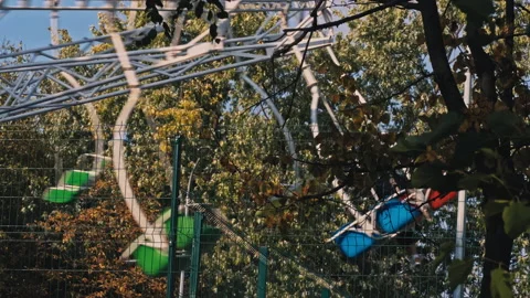 Multi-Colored Children's Swing Chamomile is Spinning in the Autumn Park Stock Footage 217353280