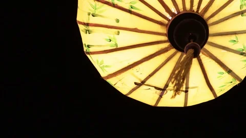 Multi-colored Chinese lanterns swing in the wind during the day. Stock Footage 119561137