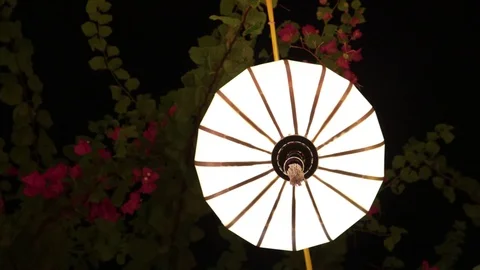 Multi-colored Chinese lanterns swing in the wind during the day. Stock Footage 119561180