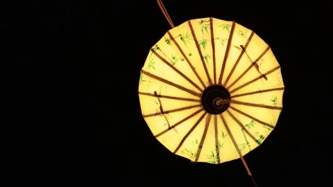 Multi-colored Chinese lanterns swing in the wind during the day. Stock Footage 119561195