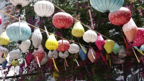 Multi-colored Chinese lanterns swing in the wind during the day. Stock Footage 119563506