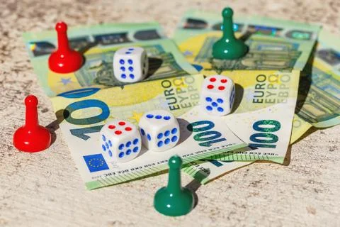 Multi-colored chips, dice of board games with hundredth euro banknotes Stock Photos