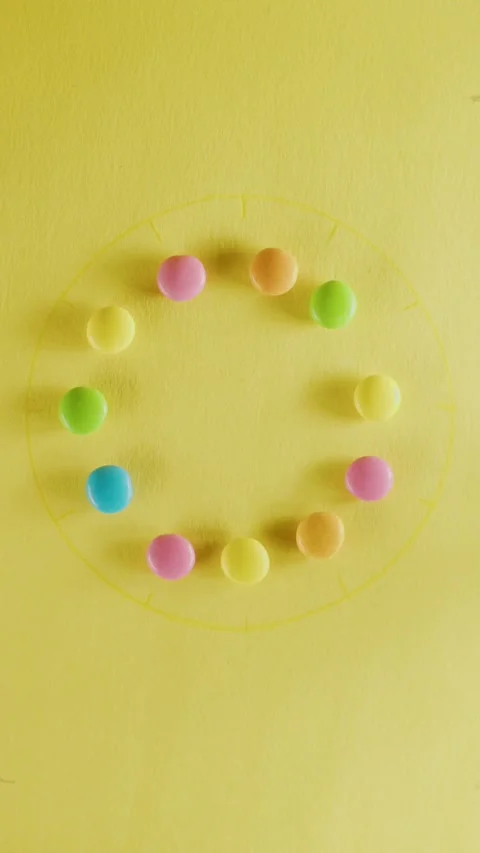 Multi-colored chocolate dragees move in a circle 스톡 동영상 237705405