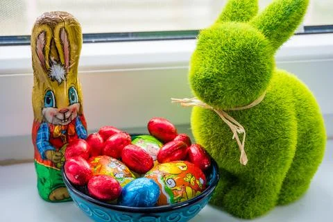 Multi-colored chocolate eggs with Easter Bunnies, seasoned for the feast Easter Stock Photos