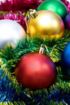 Multi-colored Christmas tree balls in the tinsel Stock Photos