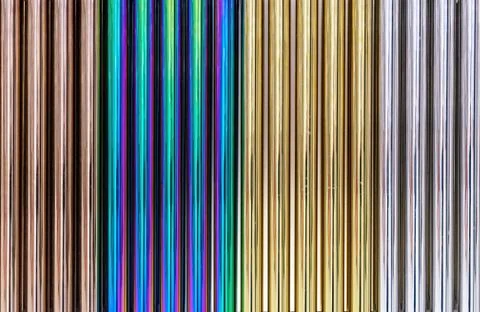 Multi-colored chrome pipes. Background from colored metal pipes. Stock Photos