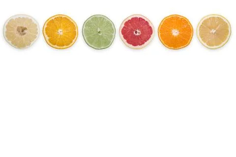 Multi-colored citrus slices on a white background Stock Photos