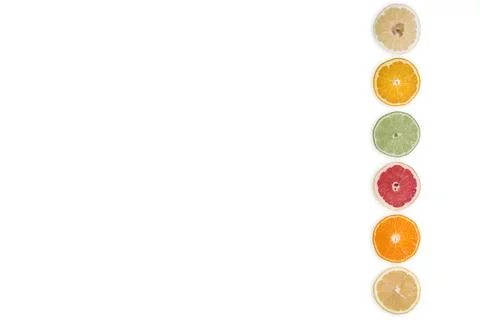 Multi-colored citrus slices on a white background Stock Photos